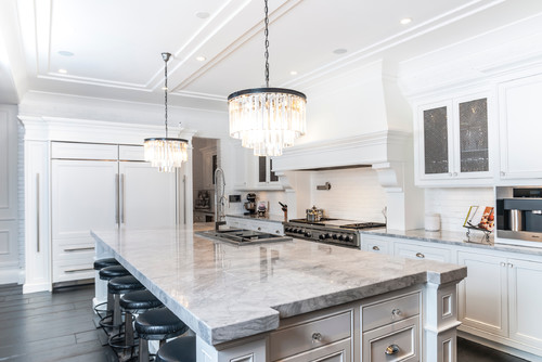 White Fantasy with Untinted White Cabinets and White Brick Backsplash and Dark Hardwood Floor.